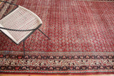 Distressed Persian Mir Serbend carpet, cherry red boteh field and geometric main border.