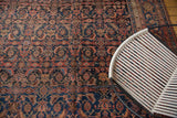 Herati motif and distinctive samovar border on vintage Persian Bijar carpet in navy and blush.