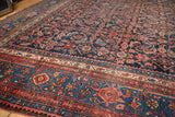 Vintage Persian Bijar carpet's main border with samovar motif and time-softened navy Herati field.