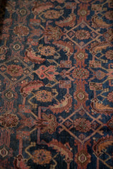 Close-up of vintage Bijar carpet, Herati motif in navy, blush, oxidized green, and time-softened pile.
