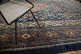 Intricate border and allover herati motif of a vintage Bibikabad carpet in navy, terra cotta, and ivory.