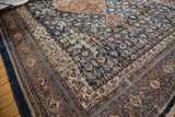Distressed navy field with textural foundation showing through a Herati motif on a vintage Persian rug.