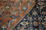 Distressed vintage Bibikabad rug: terra cotta and navy herati motifs, stepped border.