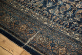 Distressed detail of vintage Bibikabad carpet, revealing blue, ivory, and sand herati mahi motifs.
