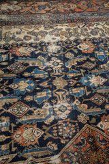 Distressed vintage Bibikabad carpet, revealing colorful herati motif and visible foundation.