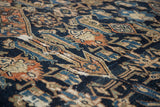 Distressed vintage Bibikabad rug with a detailed herati mahi pattern in navy, terra cotta, and blue.