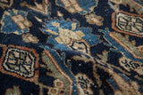 Distressed pile on a vintage Bibikabad carpet with blue, navy, and terracotta Herati motifs.