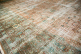 Faded European floral vinery and exposed foundation on this distressed Sarouk design rug.