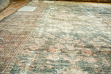 Distressed Mahal carpet texture with faded dusty teal floral blossoms and wear to knot heads.