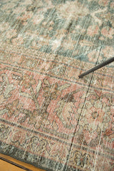 Distressed Mahal carpet pile showing mostly even wear and faded blush, dusty teal floral patterns.