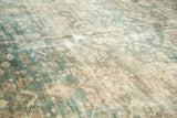 Worn pile texture of distressed Mahal carpet, with faded dusty teal and pomegranate red floral motifs.