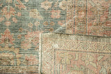 Distressed Mahal carpet pile in dusty teal and faded red, showing mostly even wear and restrung foundation.