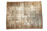 Distressed vintage Persian Mahal carpet, showcasing faded vinery in ivory, rust, and green.