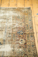 Distressed Mahal carpet side, showing mostly even worn knot heads and antique ivory geometric patterns.