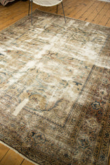 Distressed Mahal carpet with detailed dark rust and charcoal border, revealing antique ivory foundation.