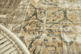 Distressed Mahal carpet detail: antique ivory, forest green vinery with worn knot heads.