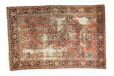 Distressed Mahal carpet with pale brick red floral field and navy samovar border. 6'7