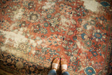 Distressed Mahal carpet detail, floral field with brick red, navy, forest green, ivory.