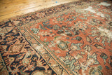 Distressed Mahal rug's brick red field with worn floral cross sections and samovar border details.