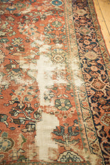 Distressed Mahal carpet with visible antique ivory foundation and intricate floral motifs.