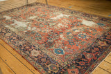 Distressed brick red field with floral motifs and navy samovar design border.