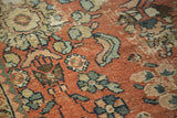 Distressed Mahal rug pile with pale brick red, powder blue, and ivory floral motifs.
