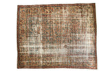 Distressed Mahal carpet with intricate herati pattern in faded teal, red, and camel tones.