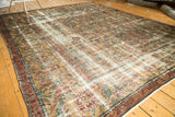 Distressed Mahal carpet's wide border with camel gold and pomegranate primitive vinery, secured end.