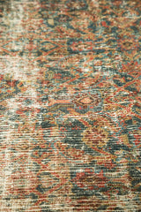 Distressed Mahal rug pile showing visible restrung foundation in teal, red, gold.
