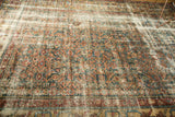 Decorative distressed Mahal carpet pile featuring faded herati motifs and muted colors.