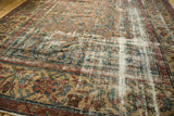 Distressed vintage Mahal carpet's worn pile reveals restrung foundation and patterns.