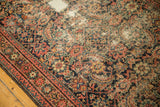 Distressed antique Fereghan runner, showing Herati motif and border in blush and dark blue.