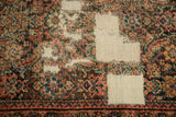 Exposed restrung foundation and worn Herati pile on the distressed Fereghan rug.