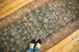 Distressed Malayer runner featuring an allover Herati motif, crab border, and faded sky blue tones.
