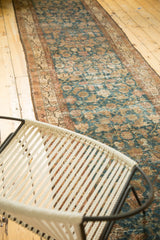 Distressed Malayer runner showcasing Herati motif, crab border, muted blues, and earthy browns.