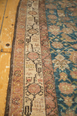 Distressed Malayer runner: aubergine crab border, ivory geometric patterns, sky blue field.