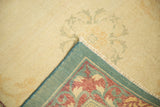 Detail of the distressed Indo Chinese carpet's reverse weave, secure edges, and worn ivory pile.