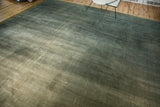 Distressed Indo Arts and Crafts carpet, showing ocean green striations, visible foundation, and subtle Laleh Abassi border.