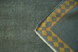 Distressed ocean green Indo Arts and Crafts rug corner, pile showing foundation, saffron Laleh Abassi border.