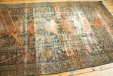 Distressed Hamadan rug with faded teal, apricot, and ivory medallion design.