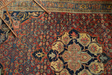 Ornate roundel medallion of the Halvaie Bijar rug, highlighting paisley boteh and cherry red Herati field.