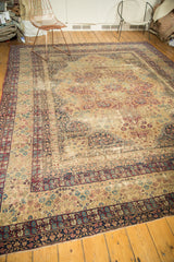 Distressed antique Kerman corner, worn mil fluer and trefoil motifs in wine red, navy, and ivory.