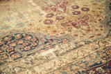 Distressed Antique Kerman carpet, displaying mil fluer motifs, trefoil border, and even pile wear.