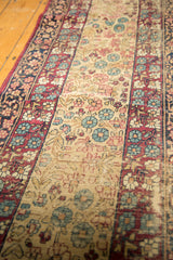 Distressed Kerman carpet pile texture, featuring mil fleur design in wine, ivory, and blues.