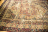 Decorative distressed Persian Kerman field, displaying faded mil fluer patterns in wine red and antique ivory.