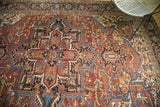 Rectilinear and curvilinear motifs in cherry red and sapphire blue on vintage Heriz.