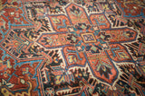 Heriz rug's ornate serrated leaves and floral arabesques in cherry red, sapphire, copper green.