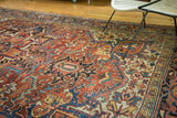 Intricate Persian Heriz pattern with rectilinear drawing, floral arabesques, cherry red, and sapphire blue.