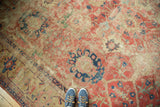 Antique Mahal carpet section with worn cinnabar red field, navy palmette, and meandering vines.