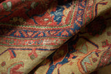 Folded antique Mahal carpet detail showing wear, cinnabar red, navy blue, and dusty gold.